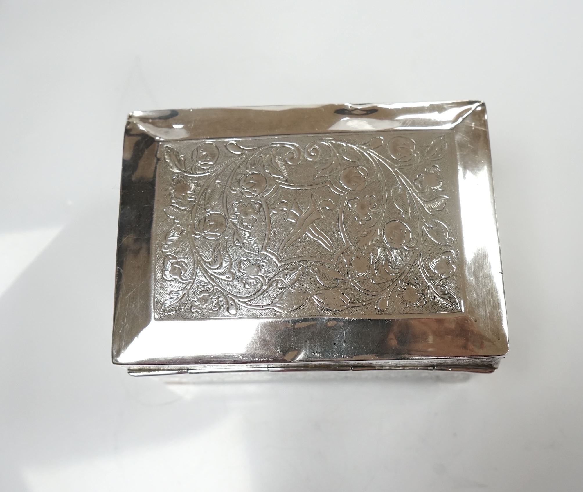 Two silver cigarette cases, a silver plated cigarette case and a Thai? white metal cigarette box, 11.6cm. Condition - poor to fair